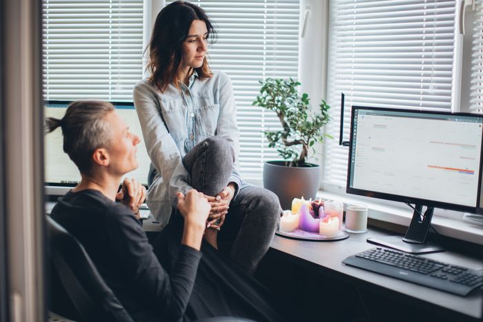 Two people holding a discussion and working together by Elina Fairytale 